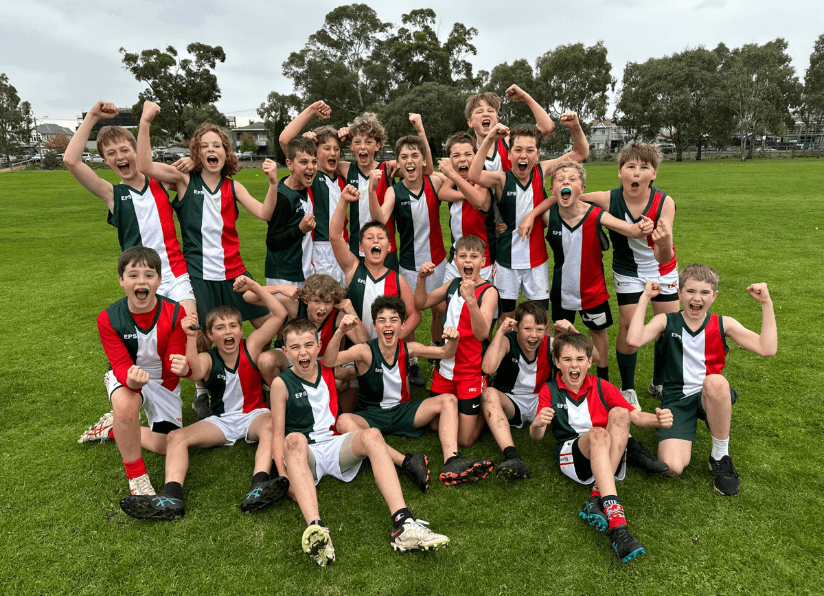 A sports group of young boys posing for a photo.